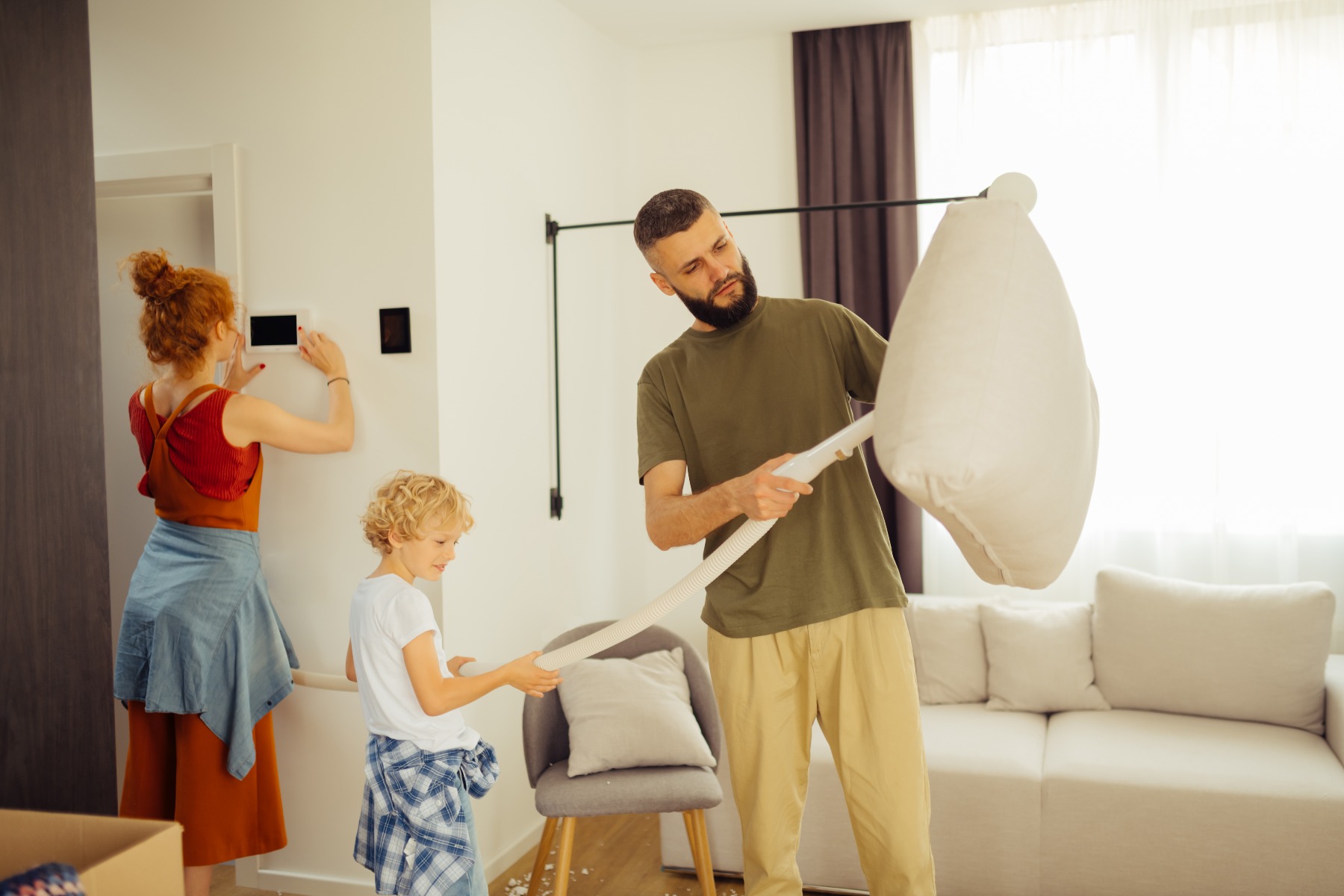 family cleaning the living room