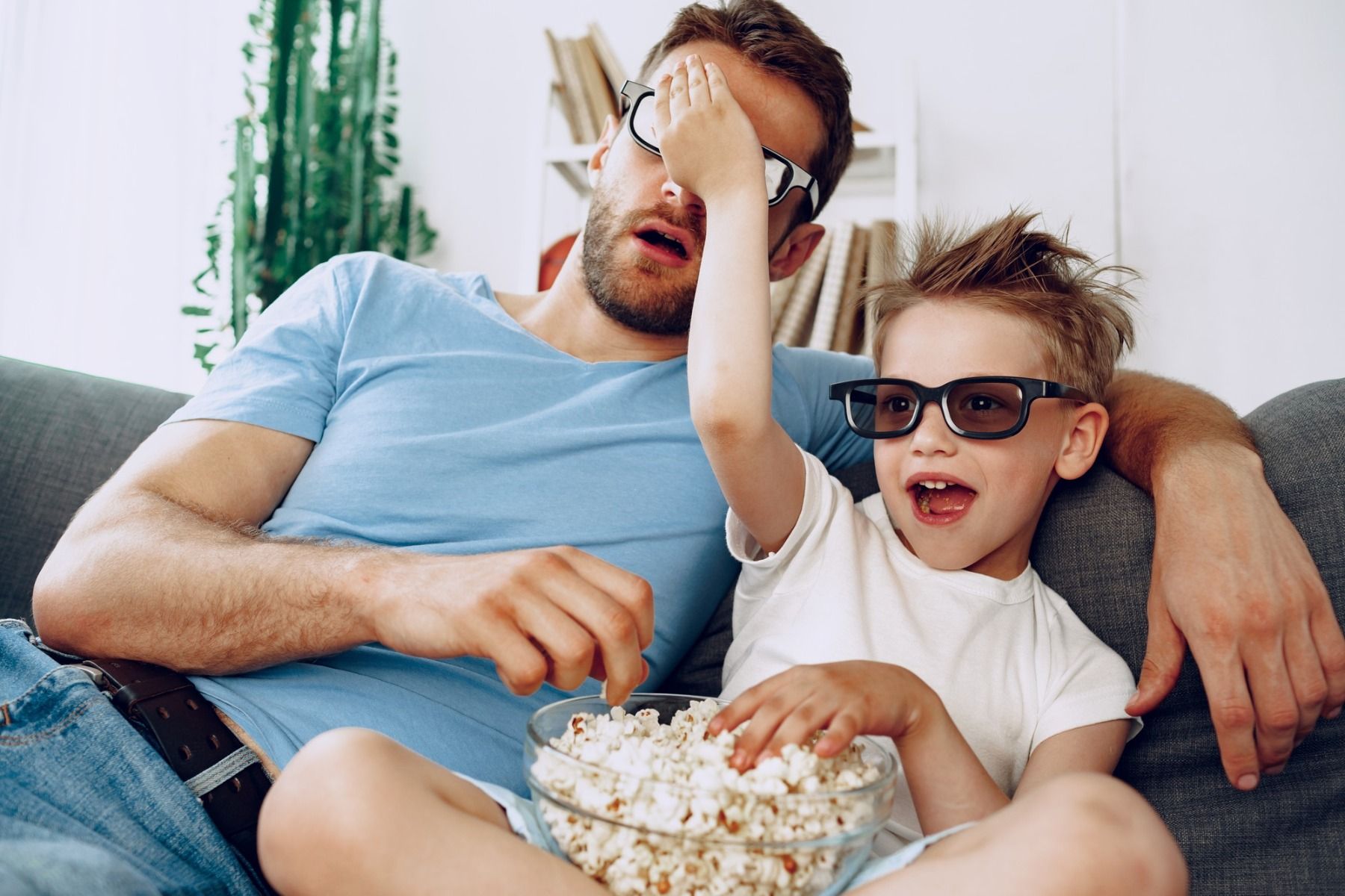 father and son watching a movie