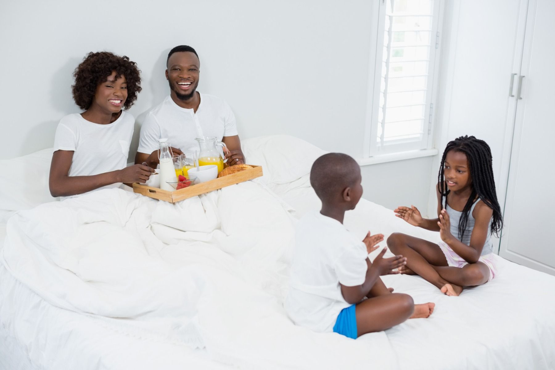 happy family eating in bed